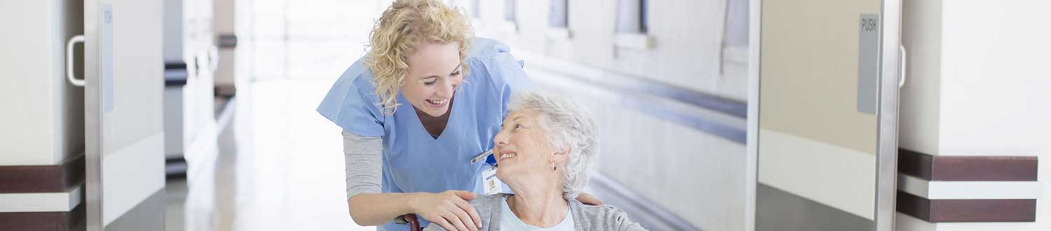 nurse helping patient in wheelchair